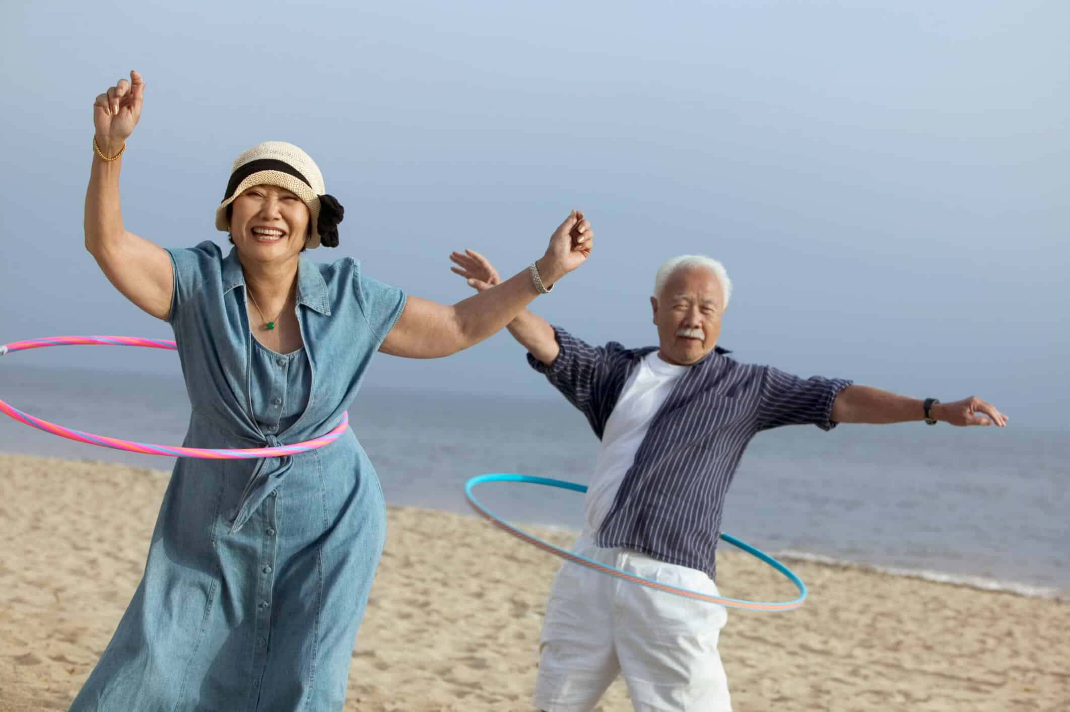 Middle-Aged Couple Hula Hooping